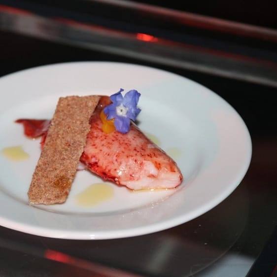 Lobster fine-dining plate with an edible flower