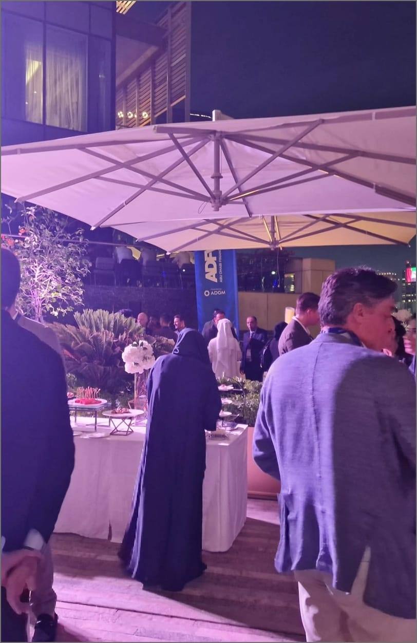Evening reception with guests beside the ADFW / ADGM stand