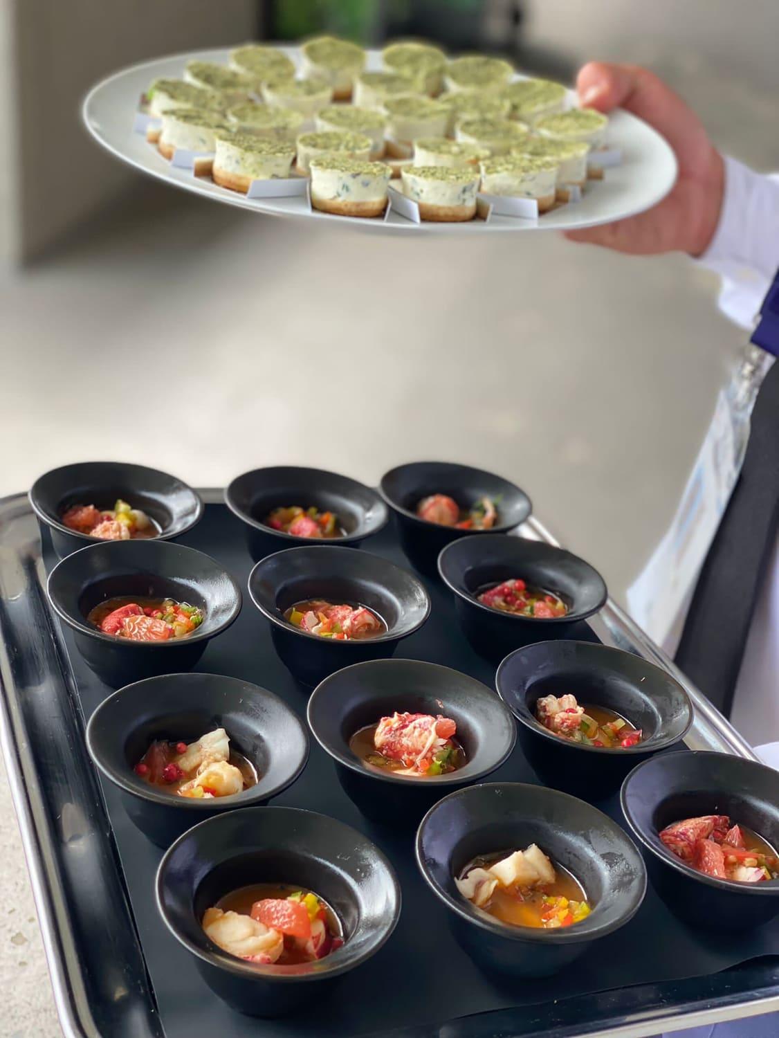 Trays of canapés and tartare verrines prepared for service