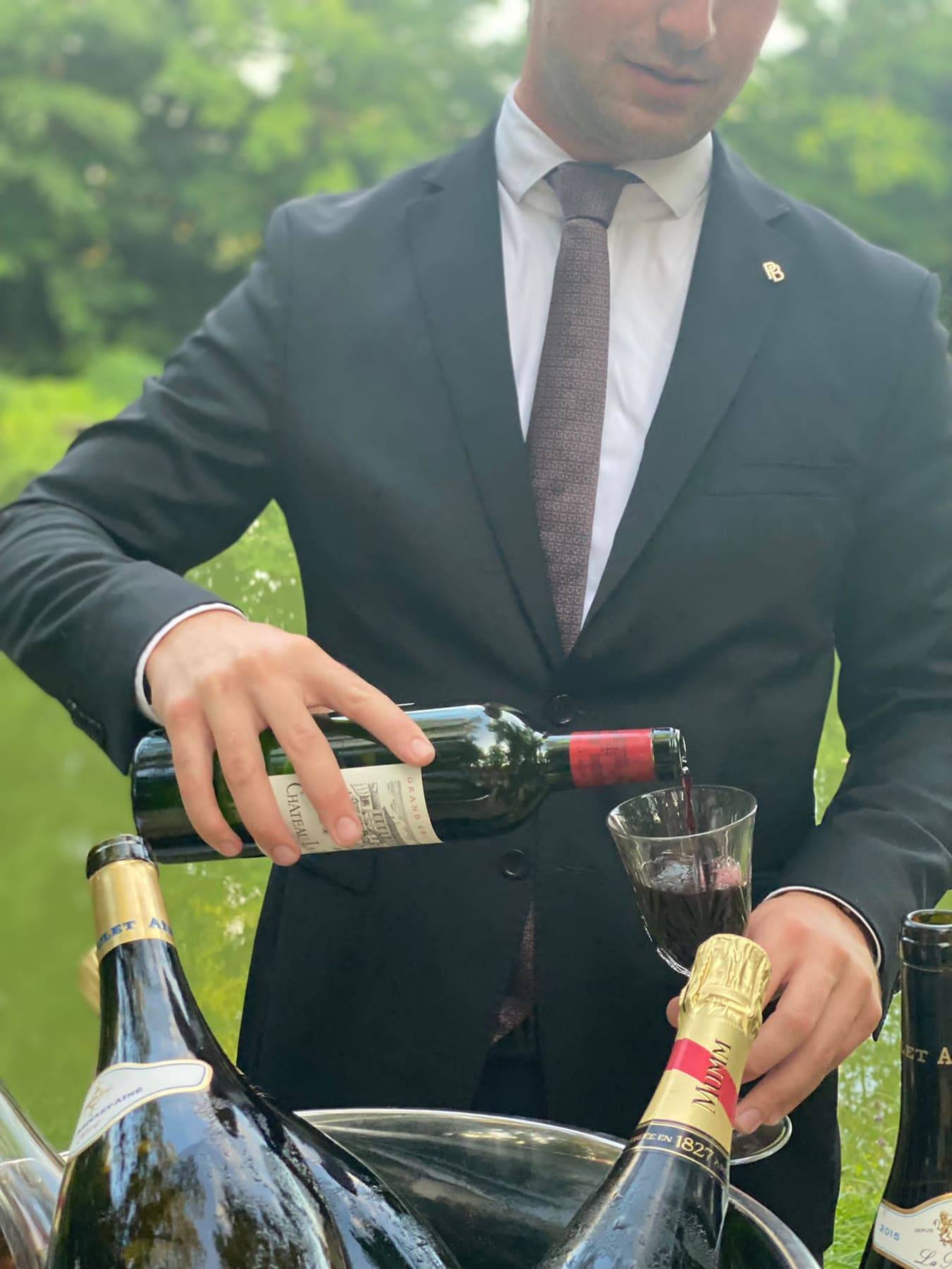Magnums of G.H. Mumm champagne on ice in a silver basin by the water