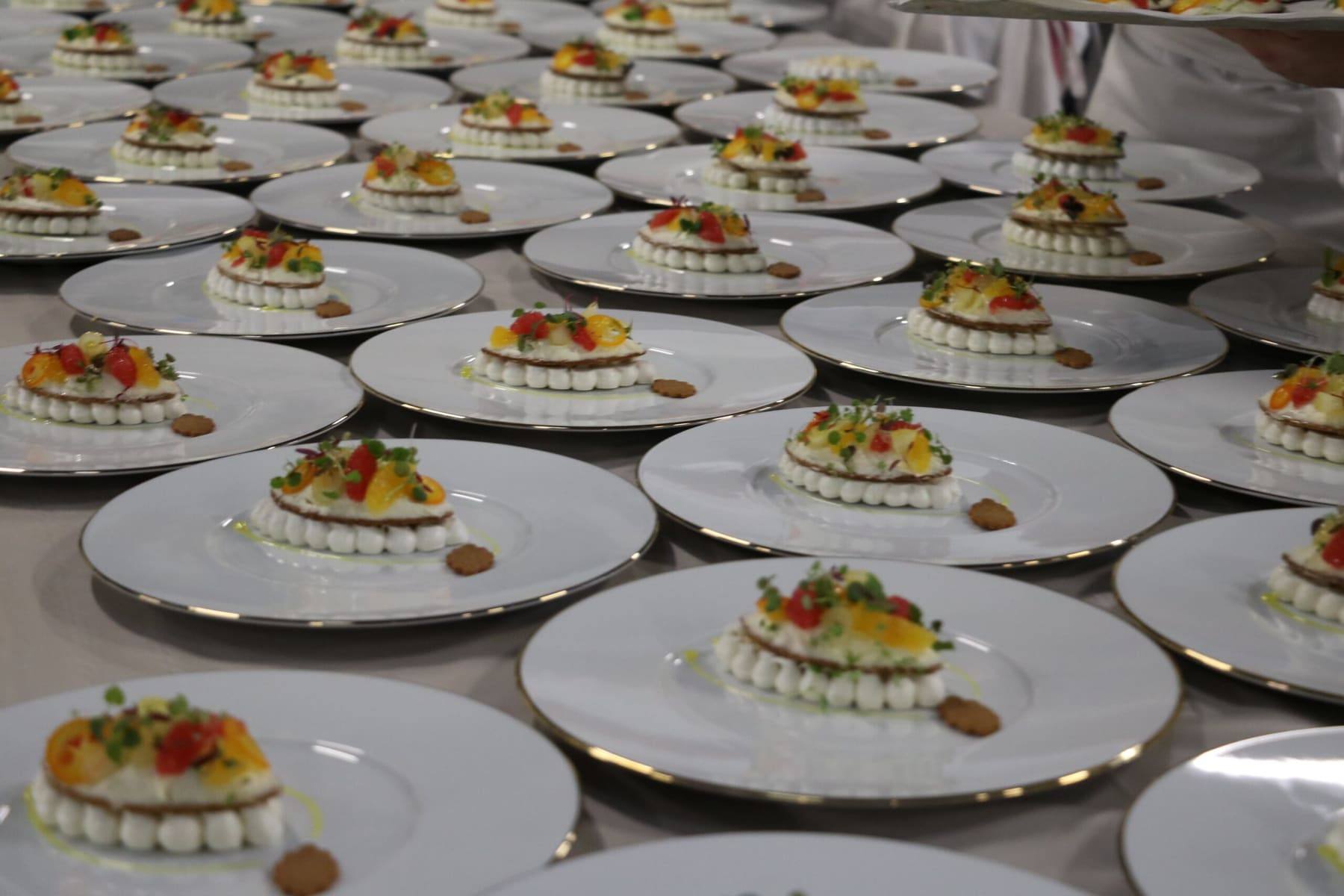 Rows of citrus-and-herb desserts plated on gilt-edged porcelain